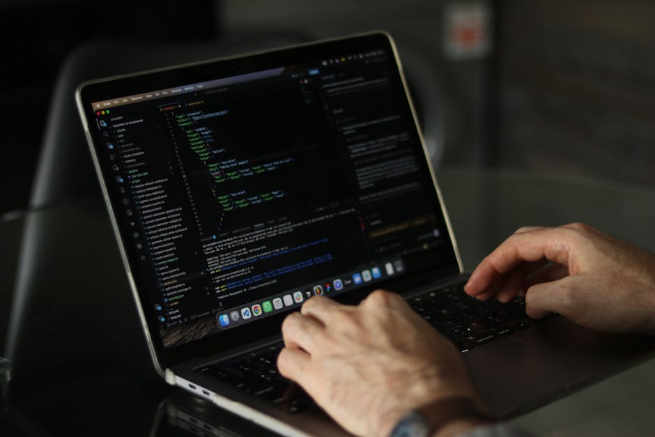 A close-up view of a computer screen displaying lines of colorful HTML and CSS code, with syntax highlighting in hues of blue, green, yellow, and red. The code appears to be part of a web development